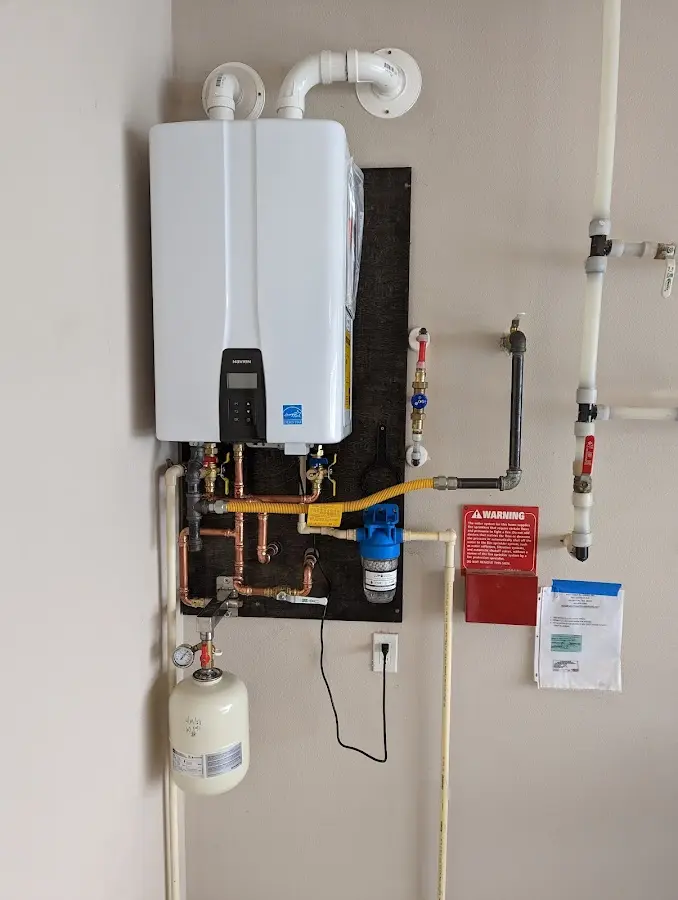 Professional plumber installing copper piping in a Manheim home